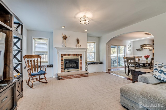 74 Gates Rd, Franklin, NJ 08873 - living room with carpet floors, arched walkways, a wealth of natural light, and a fireplace