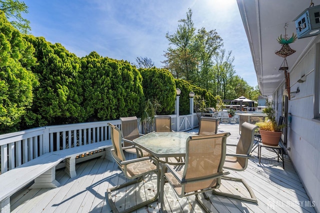 15 E Grant Ave, Colonia, NJ 07067 - wooden terrace with outdoor dining space and view of wooded area
