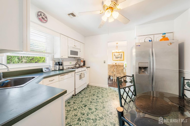 15 E Grant Ave, Colonia, NJ 07067 - kitchen featuring white appliances, dark countertops, white cabinets, ceiling fan, and a chandelier