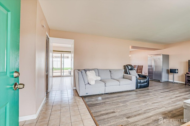 living room with baseboards and light tile patterned flooring