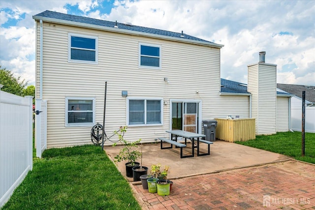back of property featuring a patio area and roof with shingles