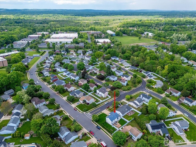 aerial overview of property's location with a forest and nearby suburban area