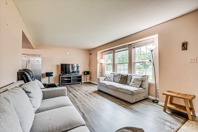 living room featuring light wood-style flooring and baseboards