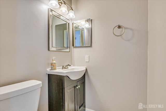 bathroom featuring toilet and vanity