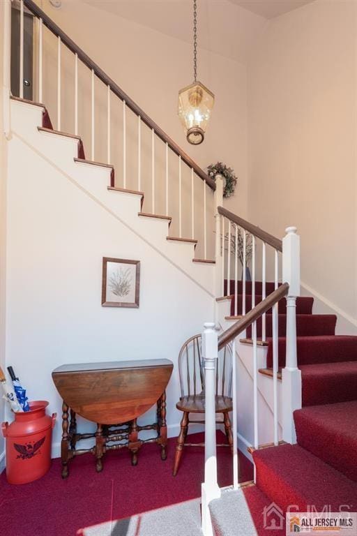 stairs with baseboards and carpet floors