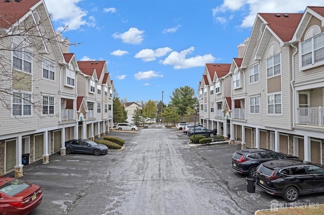 view of street with community garages and a residential view