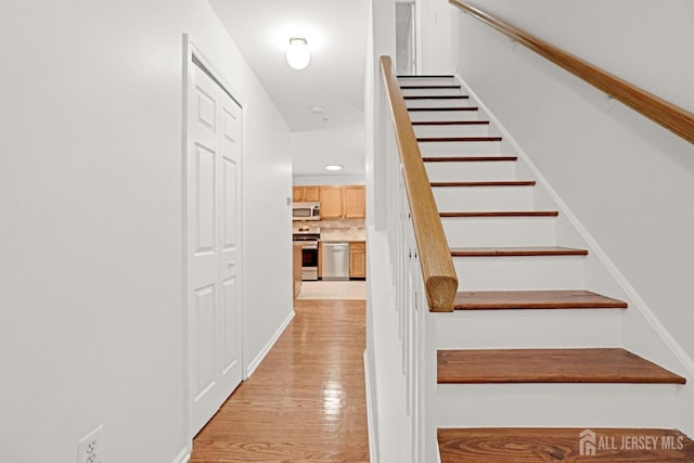 staircase featuring wood finished floors