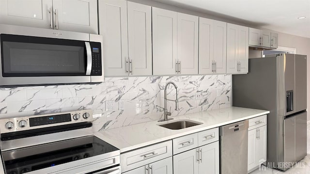 126 Jefferson Ln, Little Egg Harbor, NJ 08087 - kitchen with appliances with stainless steel finishes, a sink, light stone countertops, decorative backsplash, and recessed lighting