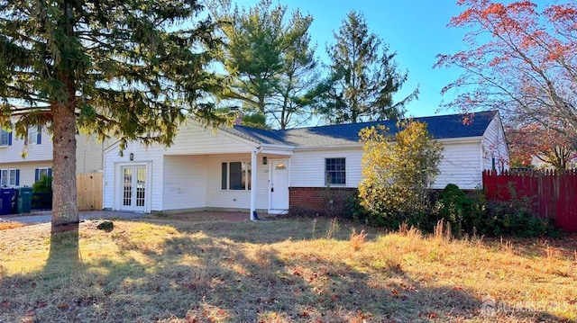 126 Jefferson Ln, Little Egg Harbor, NJ 08087 - view of front of house with fence, french doors, and a chimney