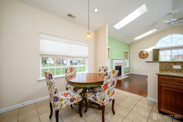 236 Valencia Dr, Monroe, NJ 08831 - dining room featuring a fireplace with flush hearth, a healthy amount of sunlight, visible vents, and a skylight