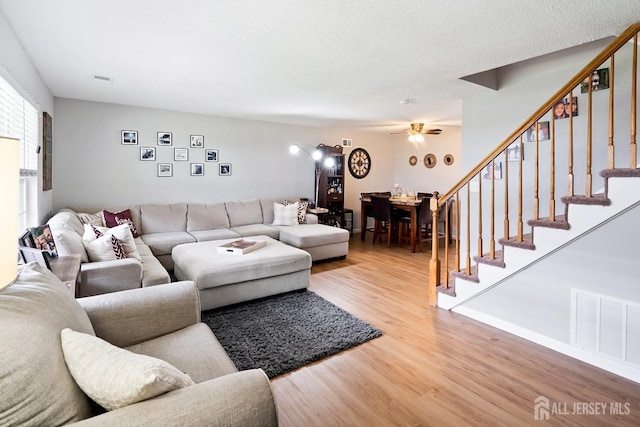 938 Thomas Ave, North Brunswick, NJ 08902 - living room featuring light wood-type flooring, stairway, and a ceiling fan