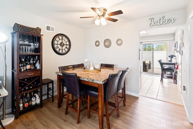 938 Thomas Ave, North Brunswick, NJ 08902 - dining area featuring a ceiling fan, light wood-style floors, and baseboards