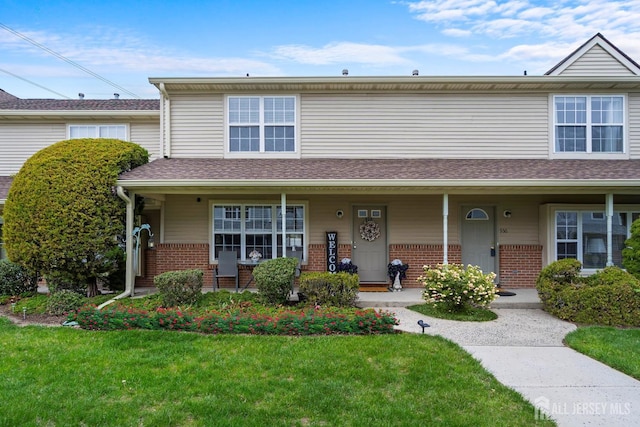 938 Thomas Ave, North Brunswick, NJ 08902 - view of property with brick siding, a front yard, and a porch