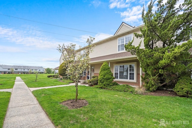 938 Thomas Ave, North Brunswick, NJ 08902 - view of front of home featuring a front yard and brick siding