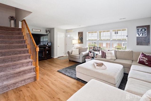 938 Thomas Ave, North Brunswick, NJ 08902 - living room featuring light wood-type flooring, stairway, and baseboards