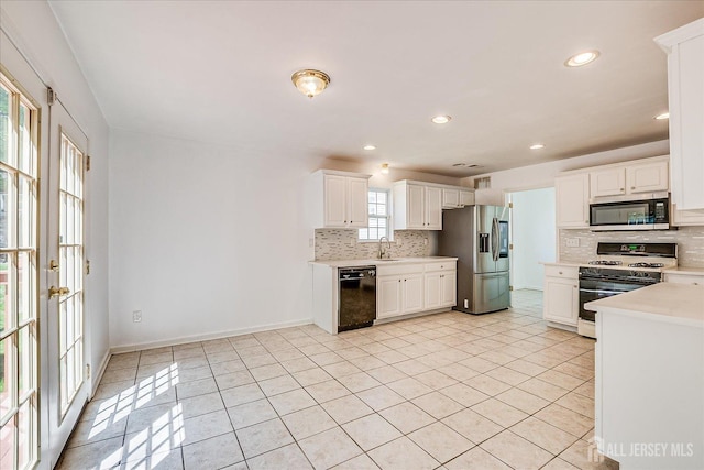 230 S 10th Ave S, Highland Park, NJ 08904 - kitchen with appliances with stainless steel finishes, light countertops, backsplash, light tile patterned floors, and recessed lighting