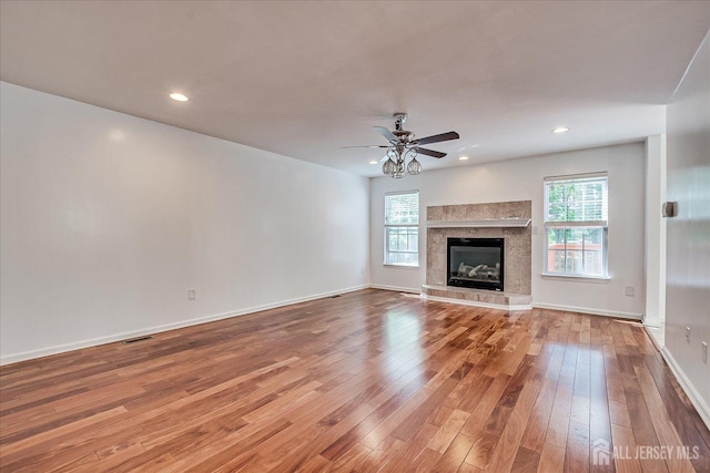 230 S 10th Ave S, Highland Park, NJ 08904 - unfurnished living room with wood-type flooring, a ceiling fan, baseboards, a tile fireplace, and recessed lighting