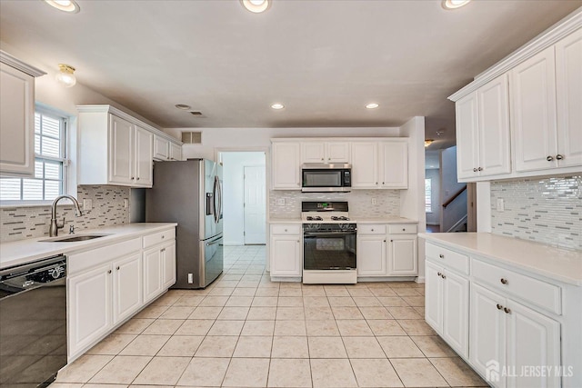 230 S 10th Ave S, Highland Park, NJ 08904 - kitchen with stainless steel appliances, a sink, backsplash, white cabinetry, and recessed lighting