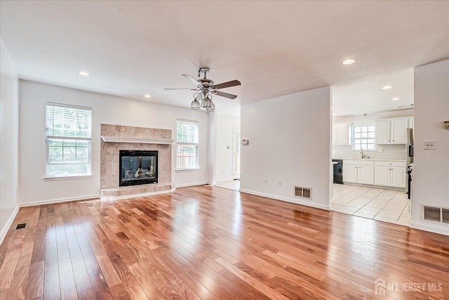 230 S 10th Ave S, Highland Park, NJ 08904 - unfurnished living room featuring light wood-style flooring, a sink, a ceiling fan, recessed lighting, and a fireplace