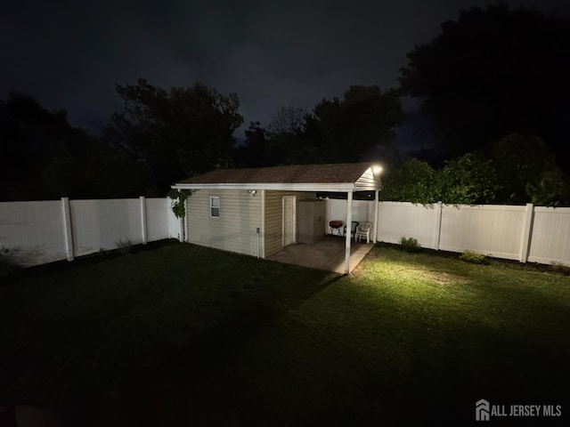860 Barry Ave, Perth Amboy, NJ 08861 - yard at twilight featuring a fenced backyard, an outdoor structure, and a patio area