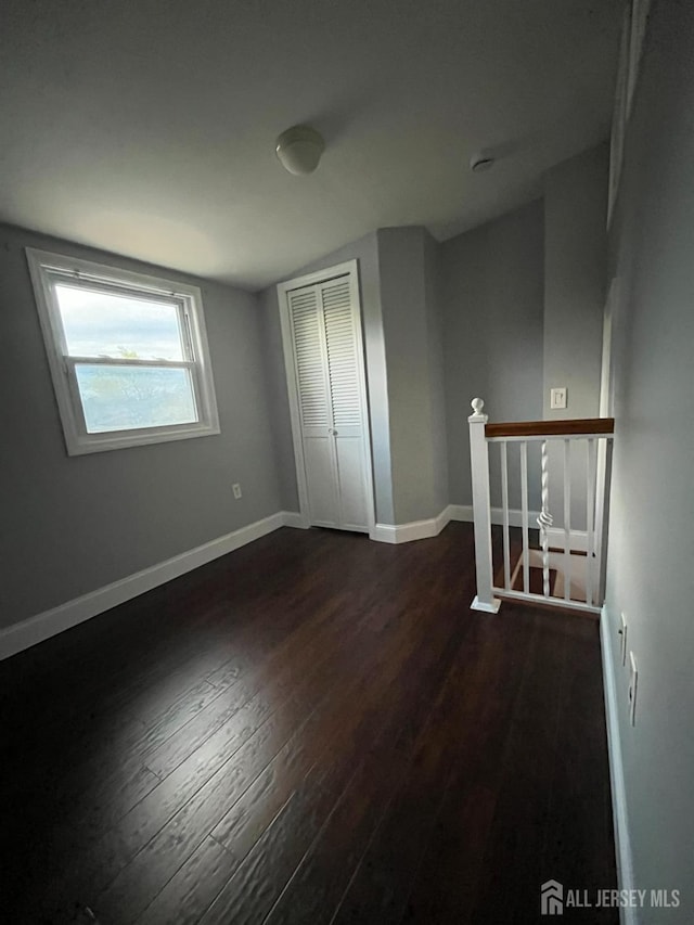 860 Barry Ave, Perth Amboy, NJ 08861 - unfurnished bedroom with dark wood-type flooring and a closet