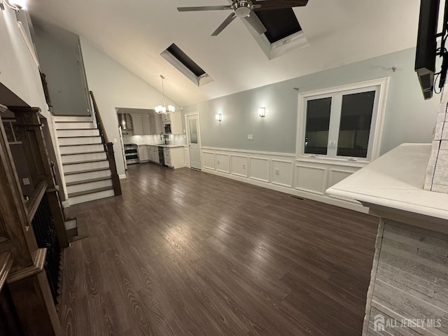860 Barry Ave, Perth Amboy, NJ 08861 - unfurnished living room with a ceiling fan, dark wood finished floors, a wainscoted wall, stairway, and a chandelier