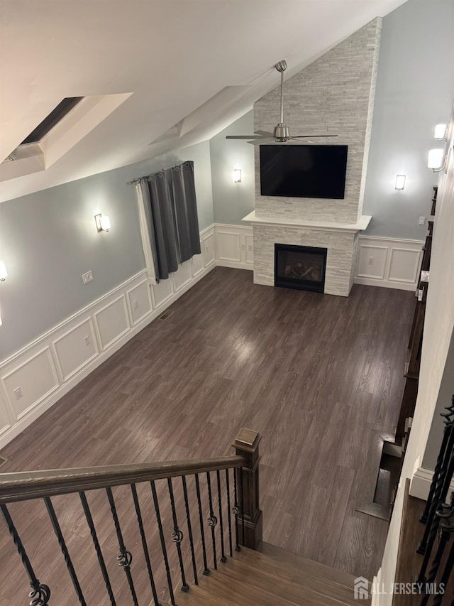 860 Barry Ave, Perth Amboy, NJ 08861 - unfurnished living room featuring a decorative wall, a large fireplace, a wainscoted wall, dark wood-style floors, and lofted ceiling