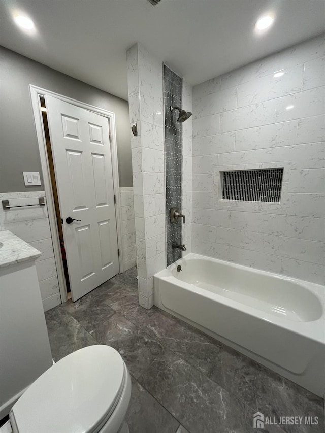 860 Barry Ave, Perth Amboy, NJ 08861 - full bathroom with washtub / shower combination, vanity, marble look tile flooring, tile walls, and recessed lighting
