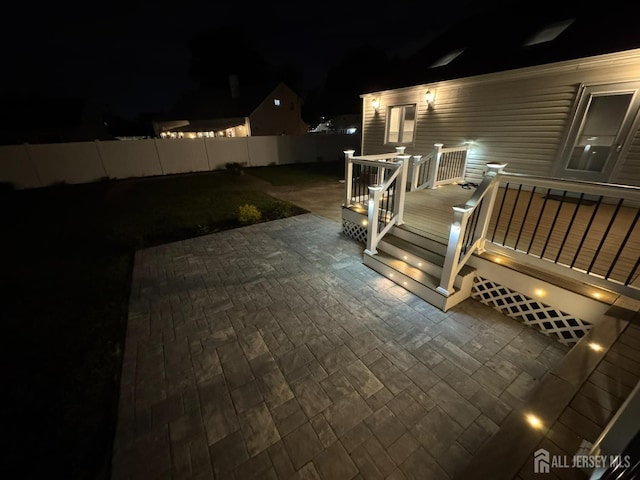 860 Barry Ave, Perth Amboy, NJ 08861 - deck at night featuring a patio