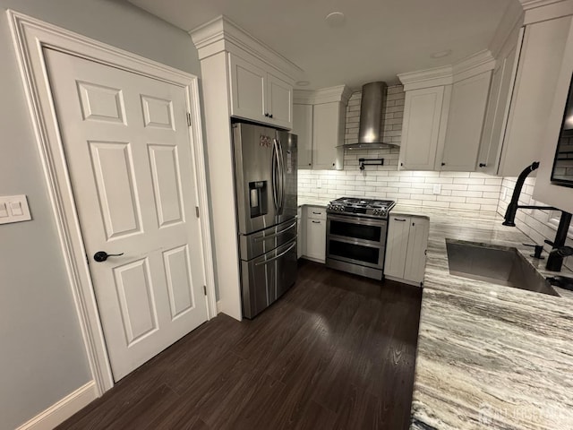 860 Barry Ave, Perth Amboy, NJ 08861 - kitchen featuring appliances with stainless steel finishes, wall chimney exhaust hood, dark wood finished floors, light stone countertops, and tasteful backsplash