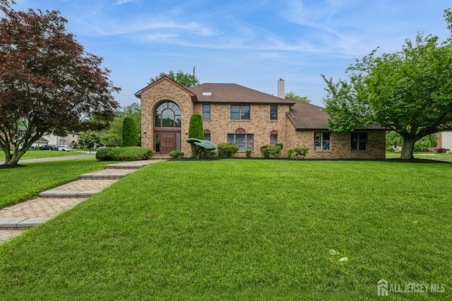 1541 Edly Cove Ct, North Brunswick, NJ 08902 - view of front of home with a front lawn, brick siding, and a chimney
