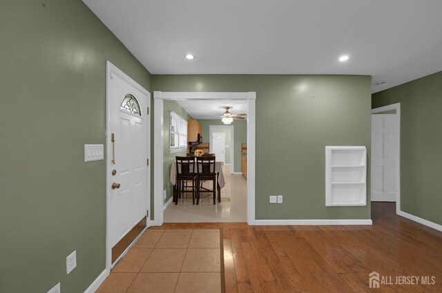 foyer entrance featuring ceiling fan and light tile patterned flooring