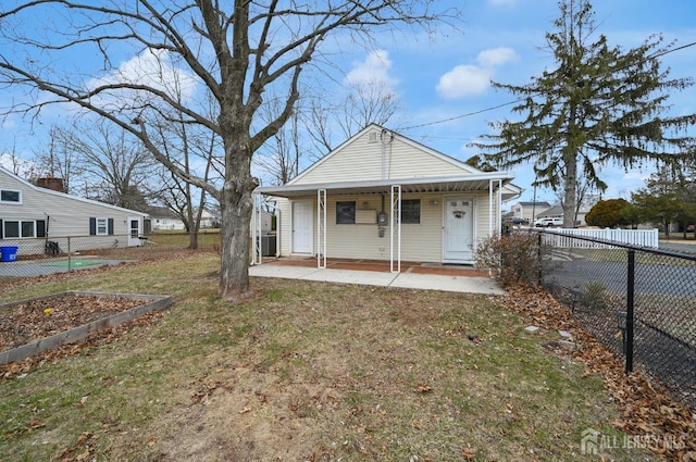 rear view of house featuring a yard and a porch