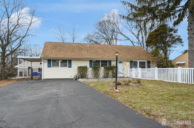 single story home with a front lawn and a carport