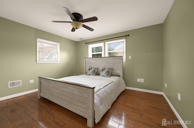 bedroom with dark wood-type flooring, ceiling fan, and multiple windows