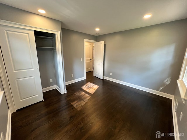 8 Woodlot Rd, East Brunswick, NJ 08816 - unfurnished bedroom featuring baseboards, dark wood-style flooring, recessed lighting, and a closet