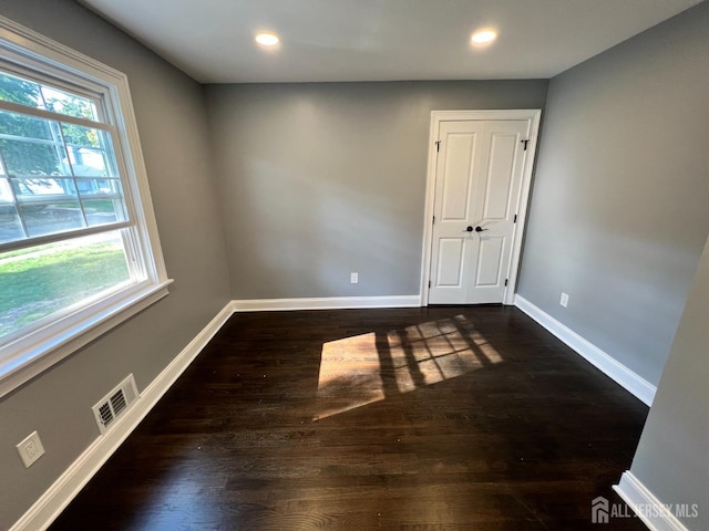 8 Woodlot Rd, East Brunswick, NJ 08816 - empty room featuring healthy amount of natural light, dark wood-style flooring, baseboards, and recessed lighting