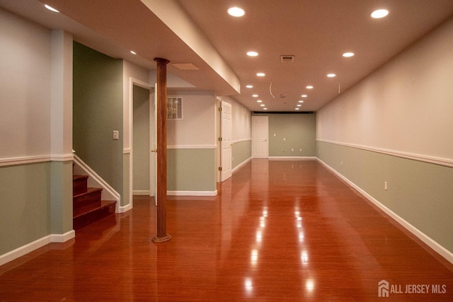 spare room featuring recessed lighting, wood finished floors, stairs, and baseboards