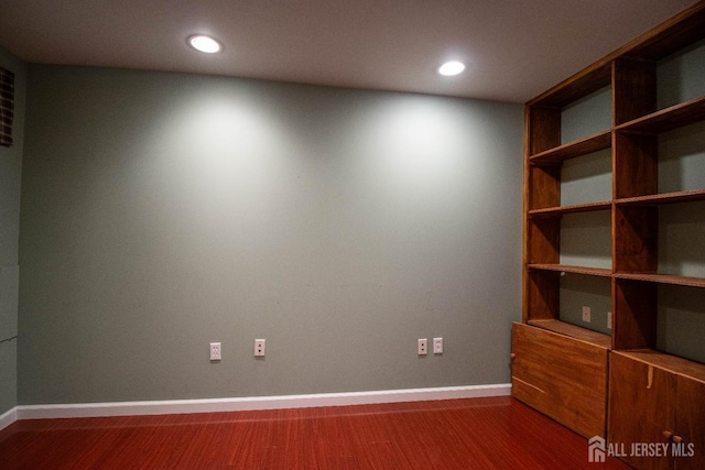 unfurnished room featuring baseboards, recessed lighting, and wood finished floors