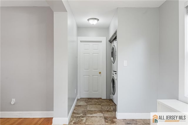 16 Lafayette Ave, Edison, NJ 08837 - laundry room with stacked washing machine and dryer, baseboards, and light stone finish floors