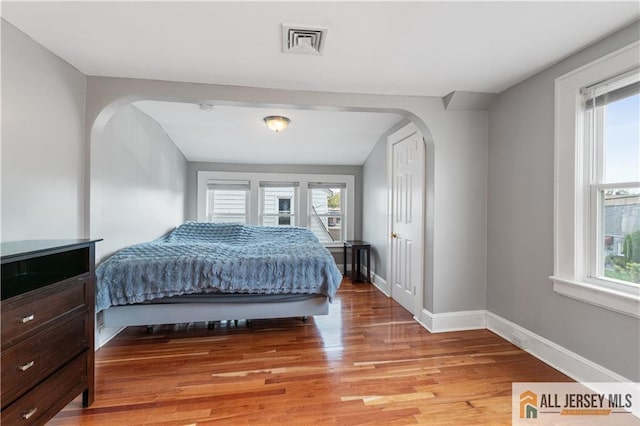 16 Lafayette Ave, Edison, NJ 08837 - bedroom with arched walkways, light wood-style floors, and baseboards