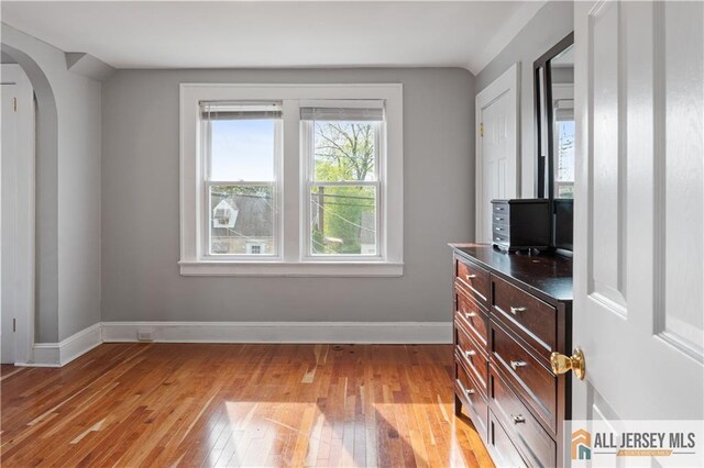 16 Lafayette Ave, Edison, NJ 08837 - bedroom featuring arched walkways, light wood-style flooring, and baseboards