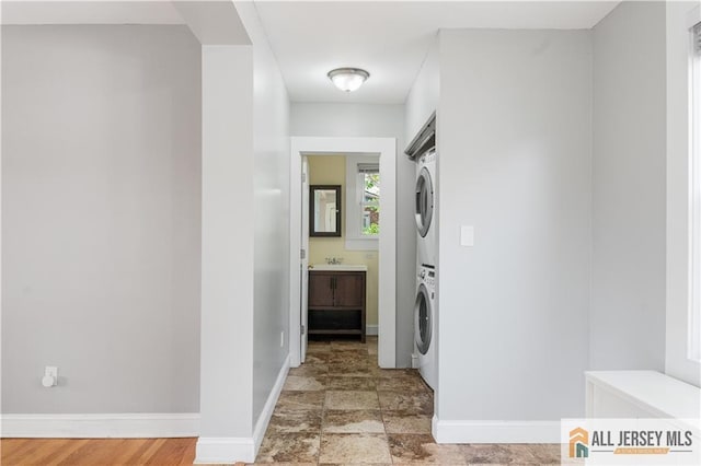16 Lafayette Ave, Edison, NJ 08837 - hallway featuring stacked washer / dryer, baseboards, and a sink