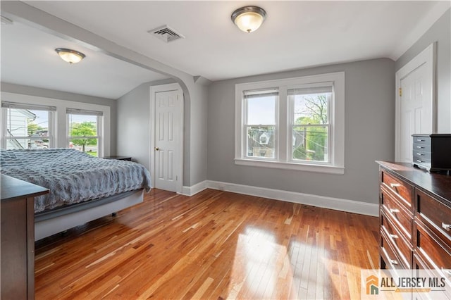 16 Lafayette Ave, Edison, NJ 08837 - bedroom featuring baseboards, light wood-type flooring, and arched walkways