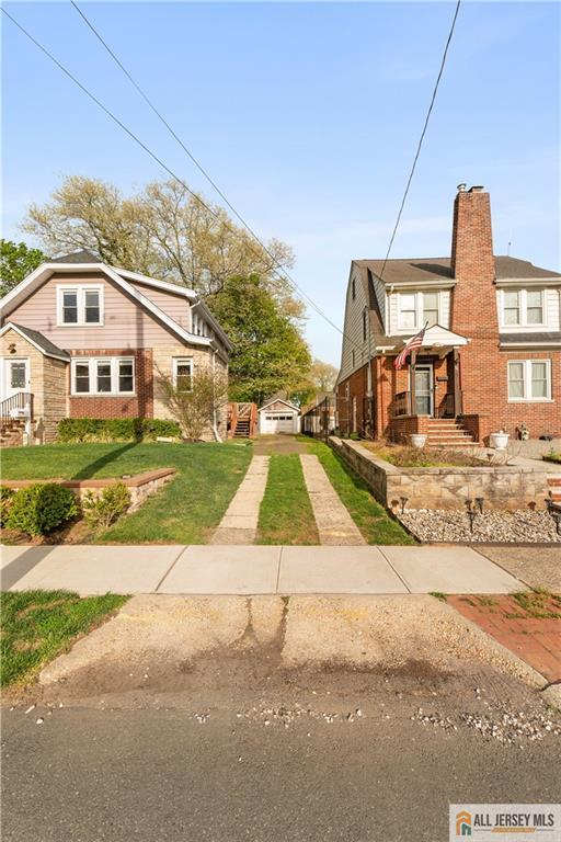 16 Lafayette Ave, Edison, NJ 08837 - view of front facade featuring brick siding and a front yard
