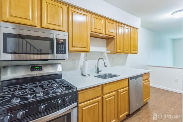 95 Lexington Cir, Old Bridge, NJ 07747 - kitchen with appliances with stainless steel finishes, a sink, light countertops, and light wood-style floors