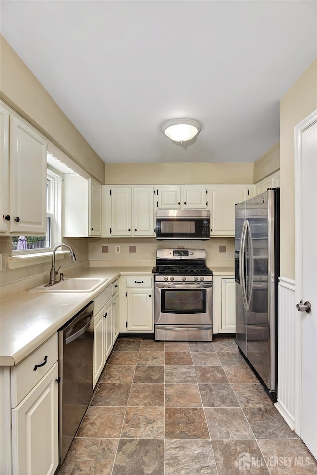 65 Brookview Cir, Jamesburg, NJ 08831 - kitchen with light countertops, appliances with stainless steel finishes, decorative backsplash, and a sink
