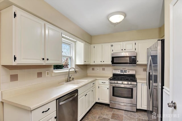 65 Brookview Cir, Jamesburg, NJ 08831 - kitchen with a sink, backsplash, stainless steel appliances, and white cabinetry
