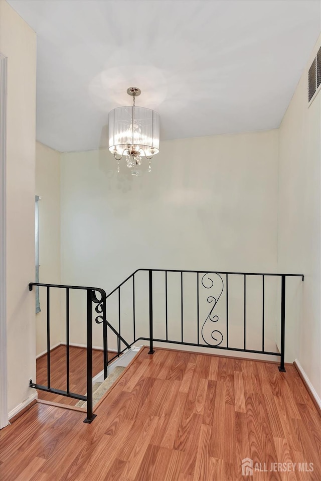65 Brookview Cir, Jamesburg, NJ 08831 - stairway featuring baseboards, an inviting chandelier, wood finished floors, and visible vents