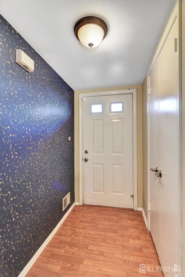 65 Brookview Cir, Jamesburg, NJ 08831 - doorway to outside with wallpapered walls, visible vents, baseboards, and light wood-style floors